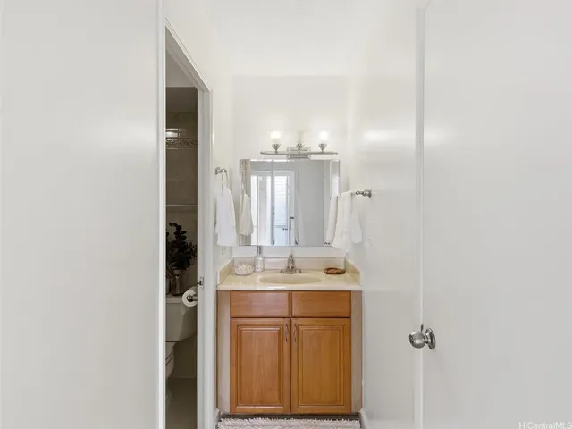 a bathroom with a sink a mirror and a vanity