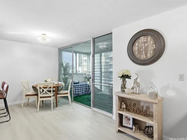 a dining room with furniture and a window