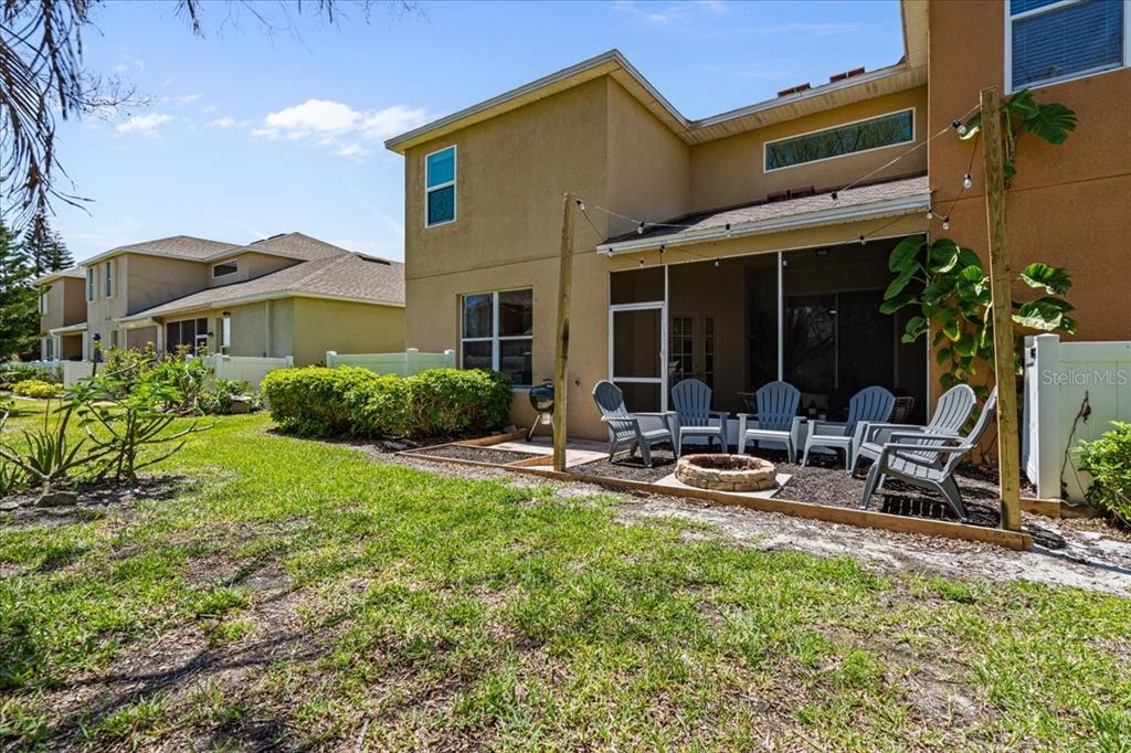3271 Titanic Circle, Unit 39 Indialantic, FL 32903 - Photo 40 of 60 a view of a house with backyard sitting area and garden