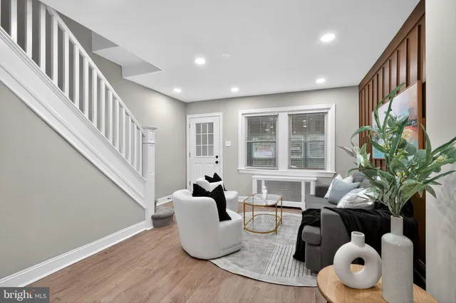 a living room with furniture and potted plant