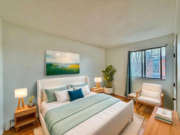 a bedroom with a bed and large window