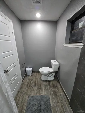 a bathroom with a toilet and a shower