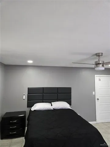 a bedroom with a bed and a night stand