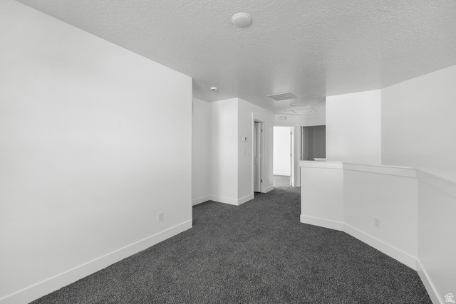 291 North Slant Road, Unit 46M Mapleton, UT 84660 - Photo 12 of 19 Unfurnished room with dark colored carpet and a textured ceiling