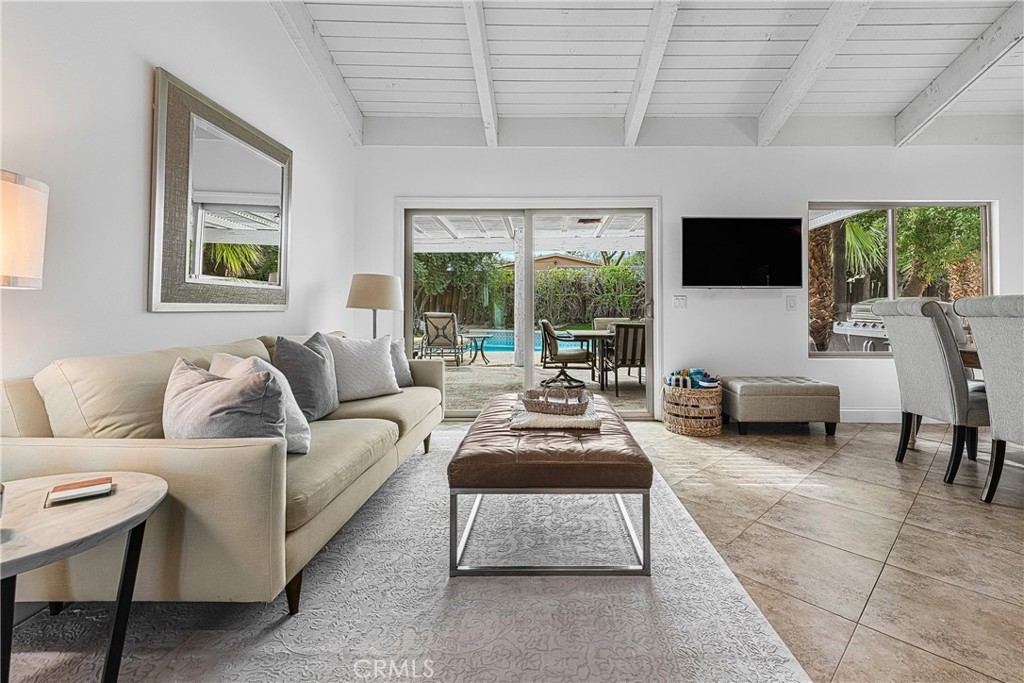 73425 Haystack Road Palm Desert, CA 92260 - Photo 14 of 30 a living room with furniture a flat screen tv and a large window