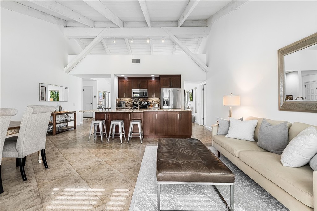 73425 Haystack Road Palm Desert, CA 92260 - Photo 15 of 30 a living room with furniture and a dining table with kitchen view