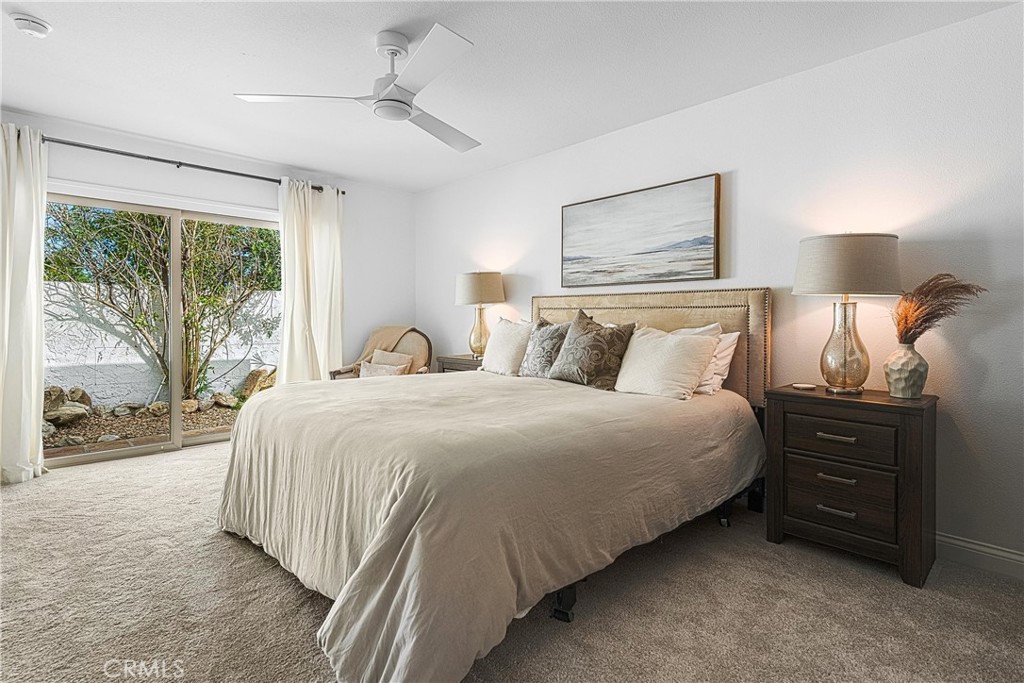 73425 Haystack Road Palm Desert, CA 92260 - Photo 24 of 30 a bedroom with a bed and a large window