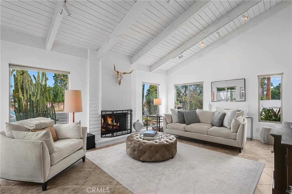 73425 Haystack Road Palm Desert, CA 92260 - Photo 5 of 30 a living room with furniture a fireplace and a large window