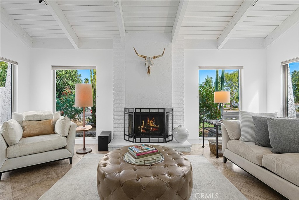 73425 Haystack Road Palm Desert, CA 92260 - Photo 6 of 30 a living room with furniture a fireplace and a large window