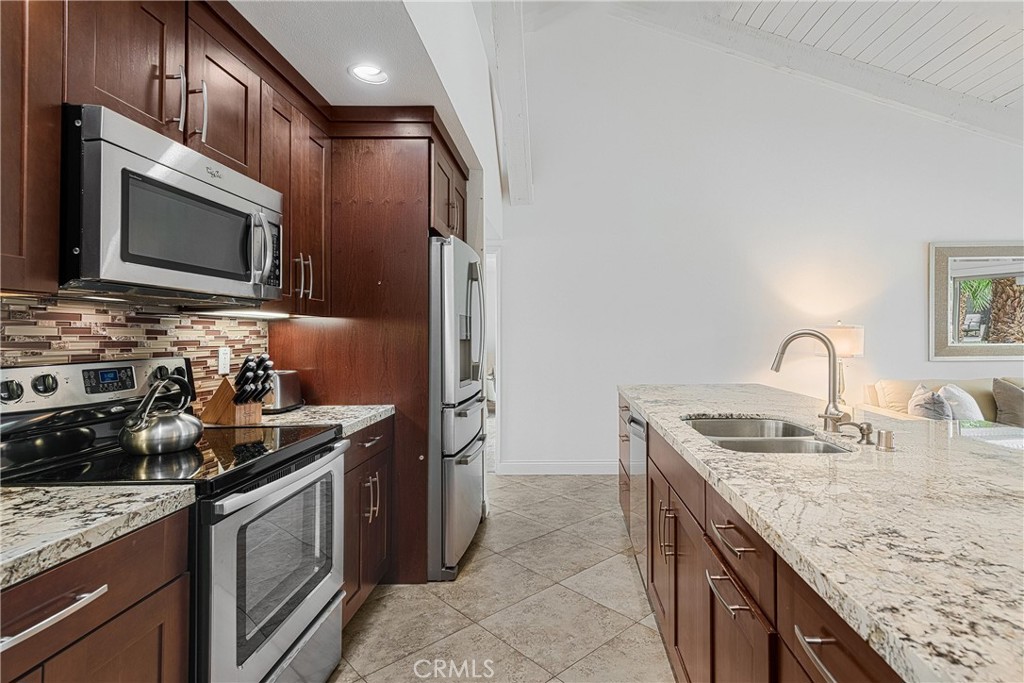 73425 Haystack Road Palm Desert, CA 92260 - Photo 10 of 30 a kitchen with stainless steel appliances granite countertop a sink stove and microwave