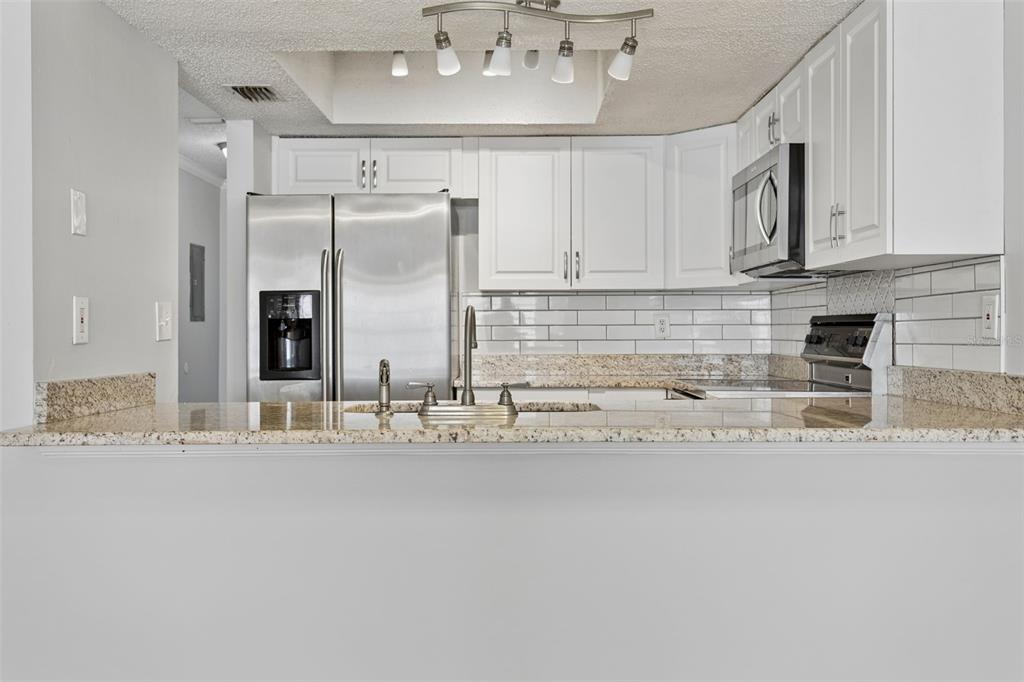10307 Councils Way Temple Terrace, FL 33617 - Photo 14 of 50 a kitchen with stainless steel appliances granite countertop a sink and cabinets