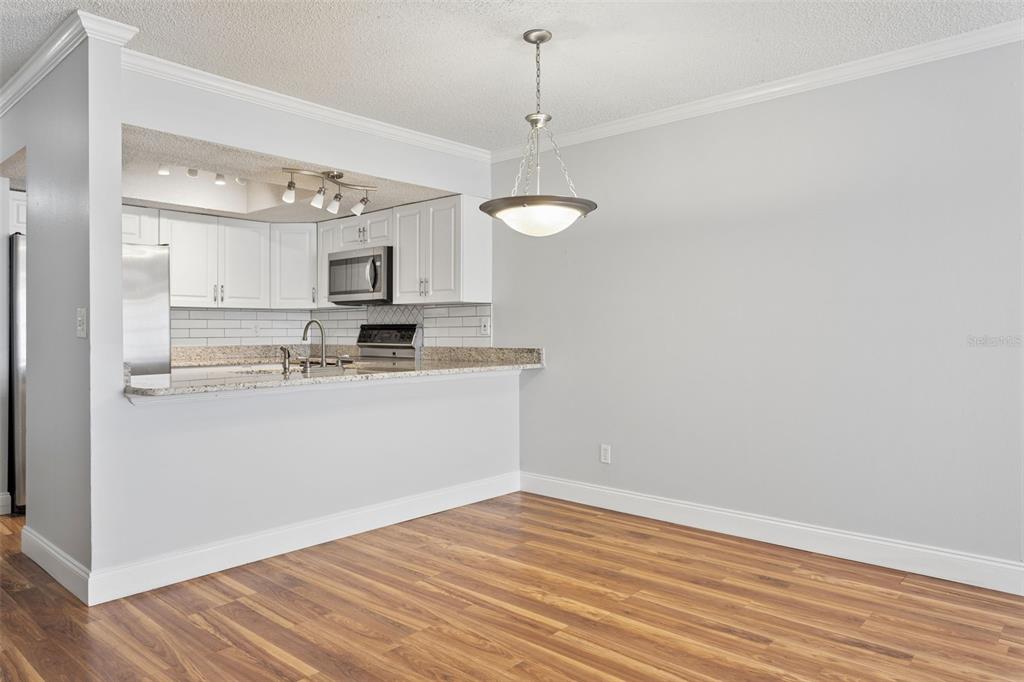 10307 Councils Way Temple Terrace, FL 33617 - Photo 17 of 50 a kitchen with granite countertop a sink cabinets and wooden floor