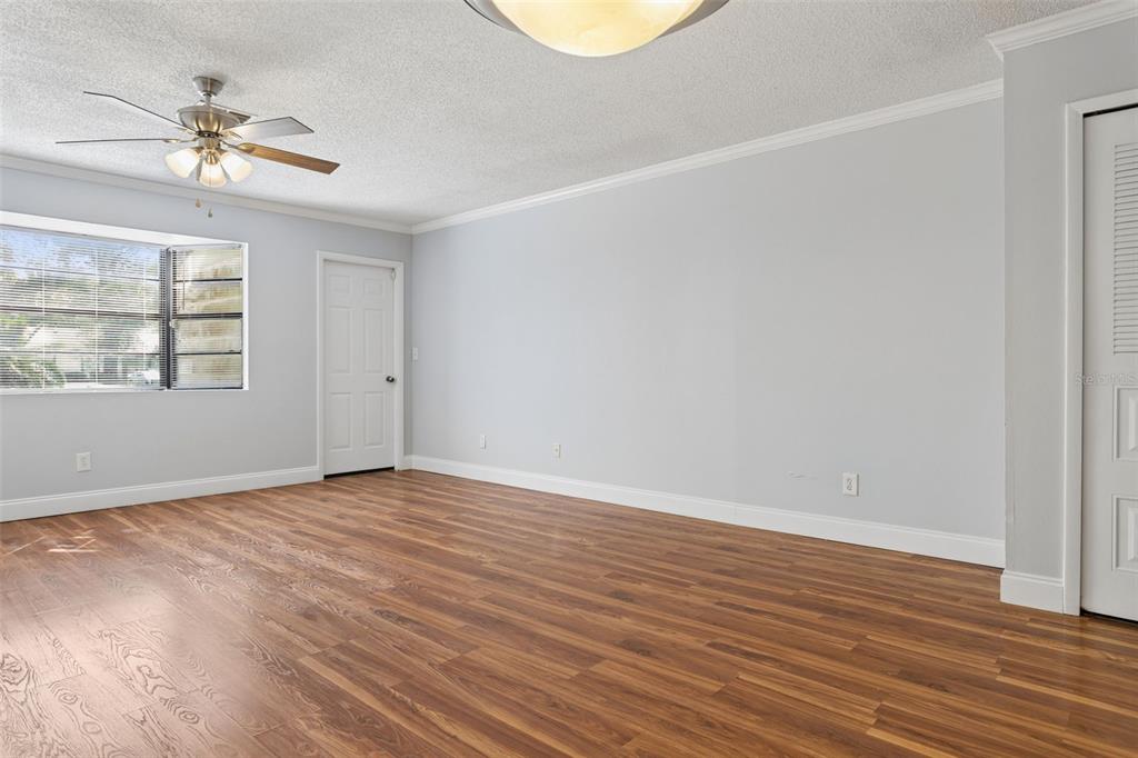 10307 Councils Way Temple Terrace, FL 33617 - Photo 18 of 50 wooden floor in an empty room with a window