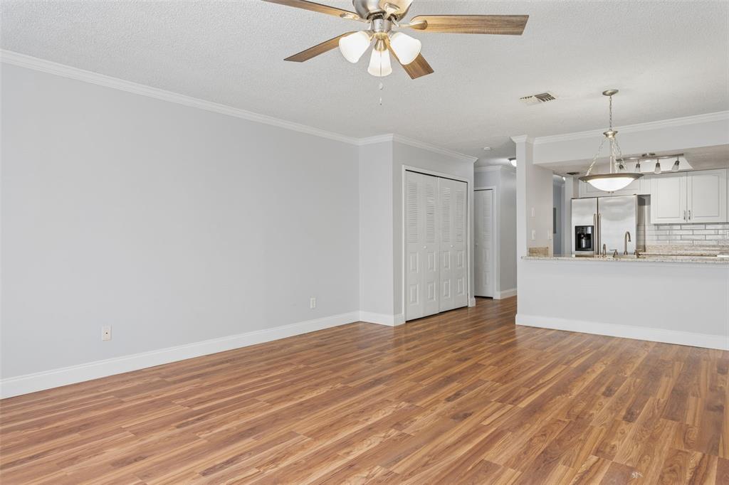 10307 Councils Way Temple Terrace, FL 33617 - Photo 19 of 50 a view of a room with wooden floor and a ceiling fan