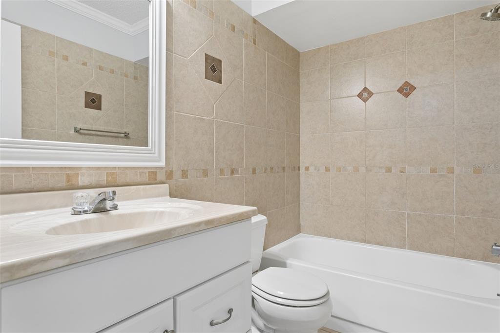 10307 Councils Way Temple Terrace, FL 33617 - Photo 27 of 50 a bathroom with a sink a toilet and a bathtub