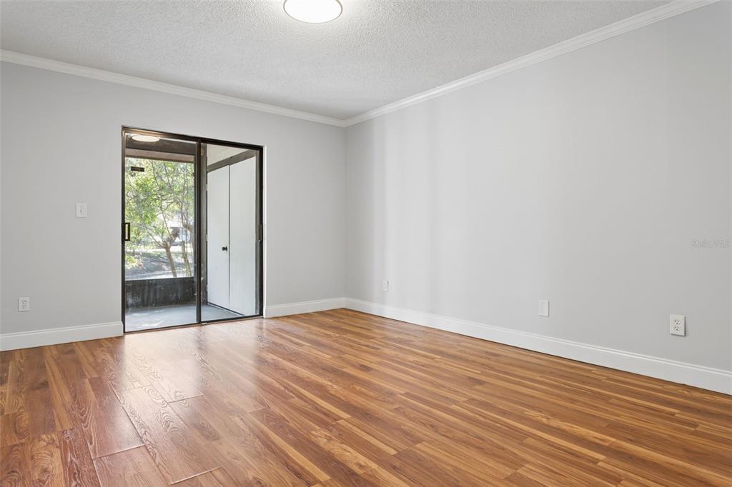 10307 Councils Way Temple Terrace, FL 33617 - Photo 33 of 50 a view of an empty room with wooden floor and a window