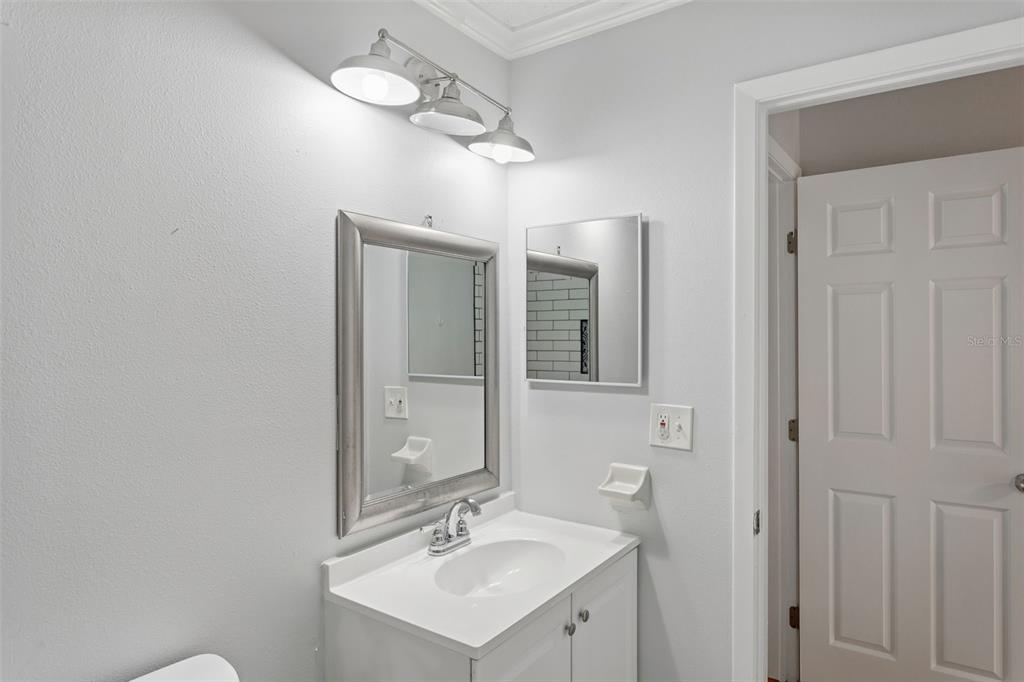 10307 Councils Way Temple Terrace, FL 33617 - Photo 39 of 50 a bathroom with a sink vanity and mirror