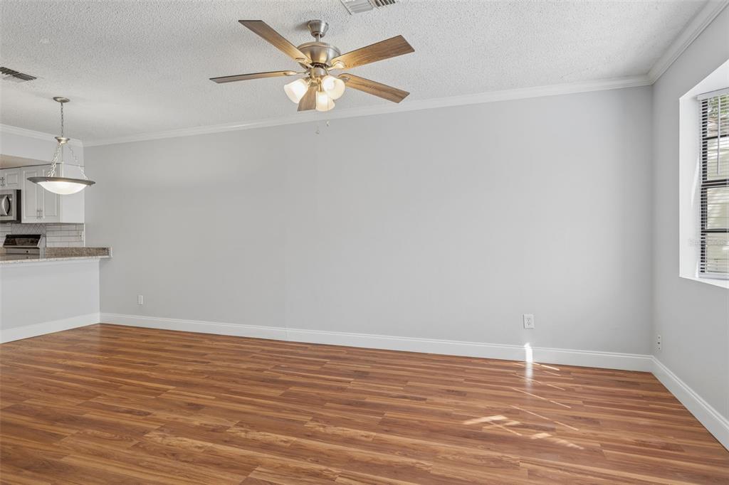 10307 Councils Way Temple Terrace, FL 33617 - Photo 40 of 50 a view of an empty room with wooden floor and a window
