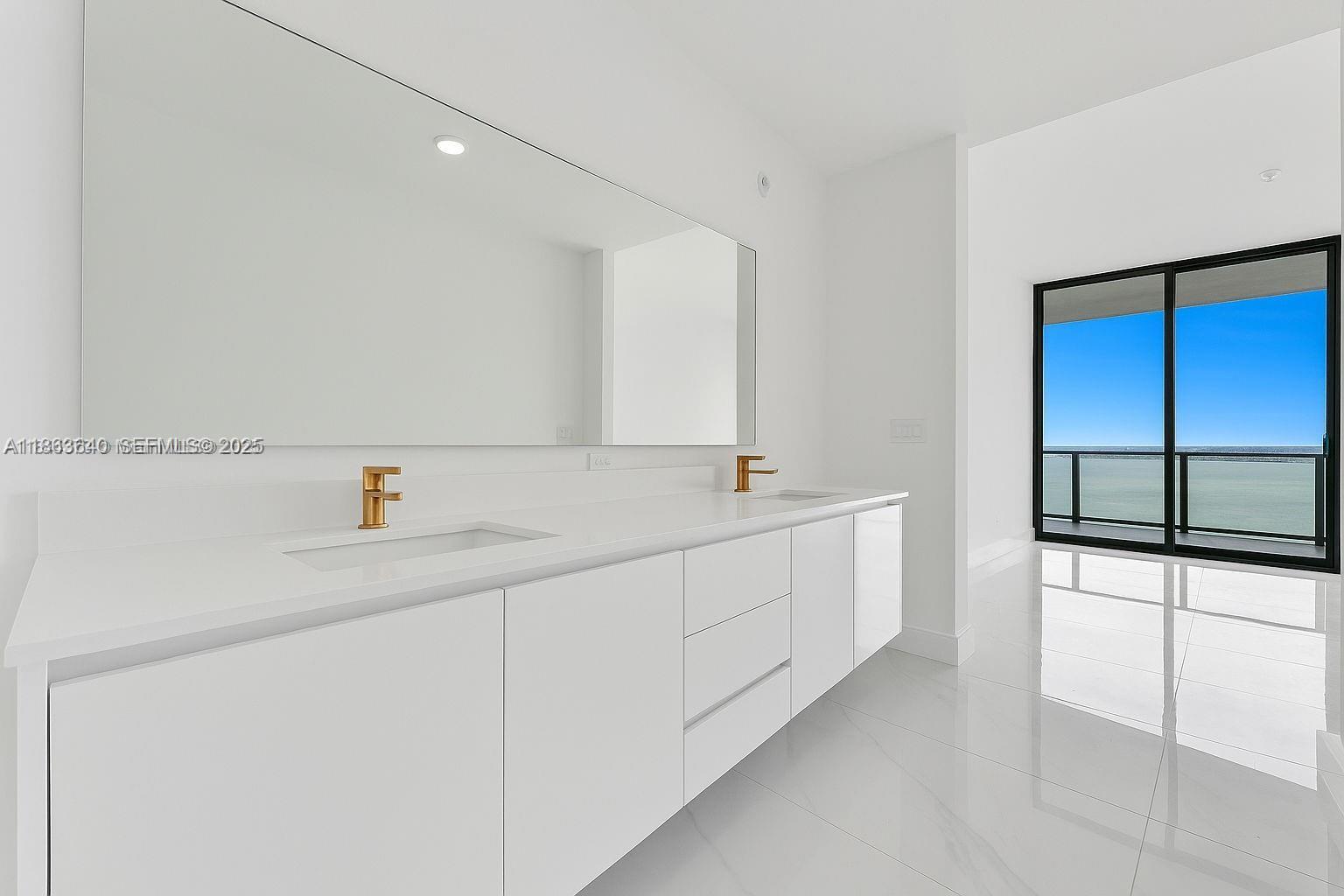 700 Northeast 24th Street, Unit 4806 Miami, FL 33137 - Photo 36 of 66 a bathroom with a double vanity sink and a