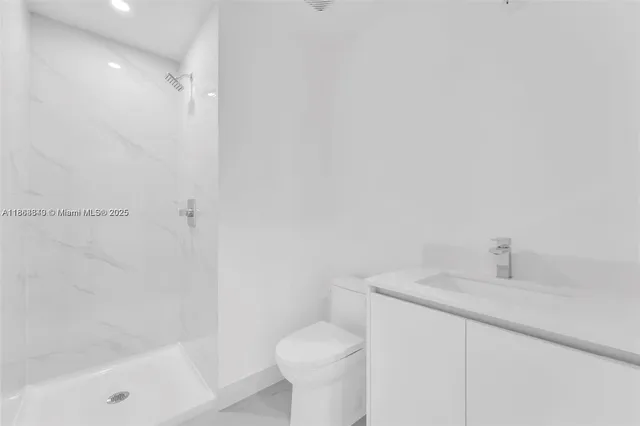 a view of a patio with couches and table and chairs under an umbrella