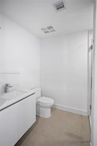 a living room with furniture and a gym machine