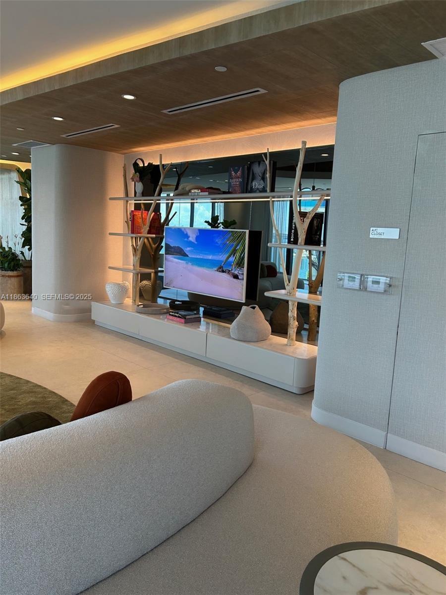 700 Northeast 24th Street, Unit 4806 Miami, FL 33137 - Photo 51 of 66 a living room with furniture and a gym machine