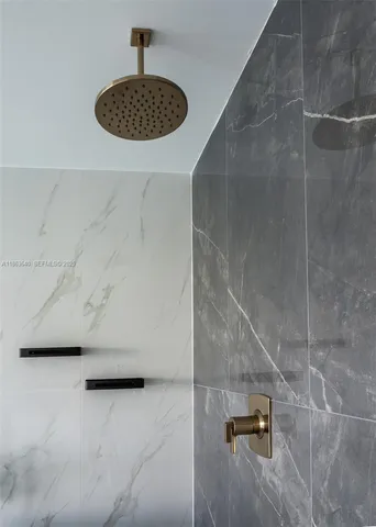 an aerial view of ocean and residential houses with outdoor space