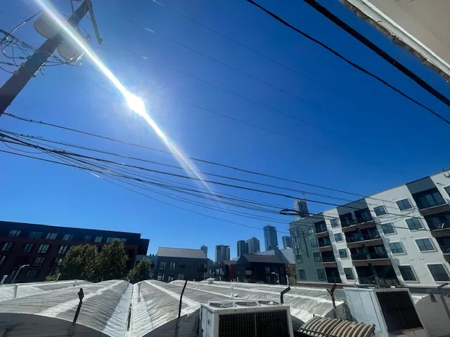 a view of a patio with chairs and potted plants