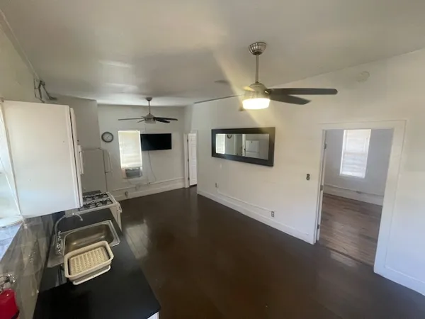 a view of a livingroom with furniture and a ceiling fan
