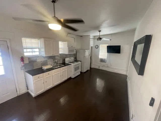 a kitchen with stainless steel appliances a refrigerator a sink a stove and a window