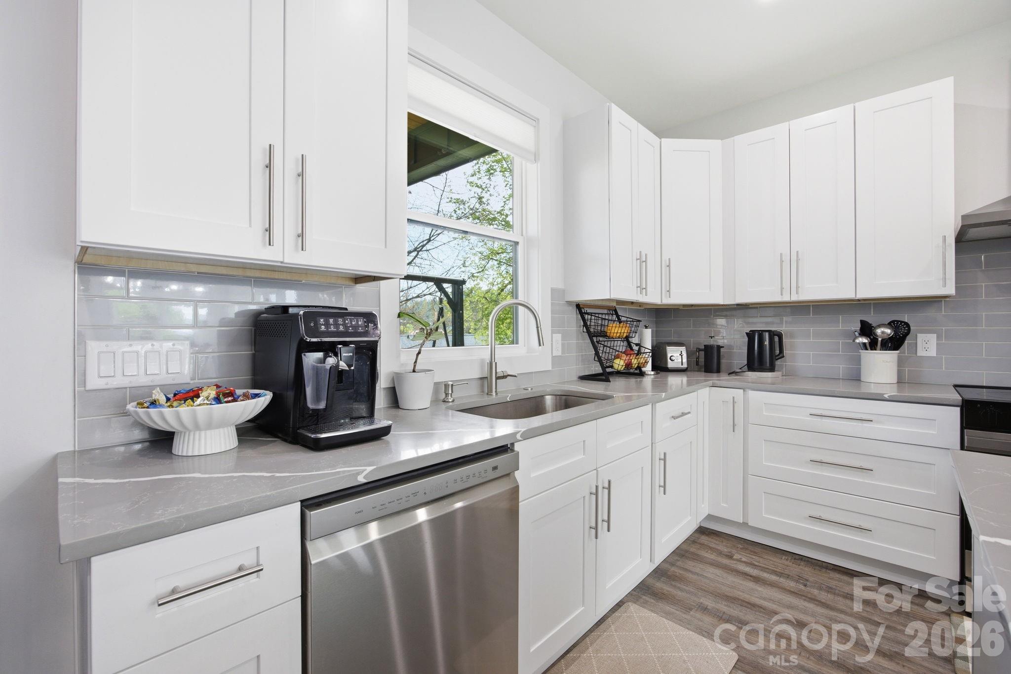 30 1st Street Canton, NC 28716 - Photo 11 of 39 a kitchen with stainless steel appliances granite countertop a sink a stove and cabinets