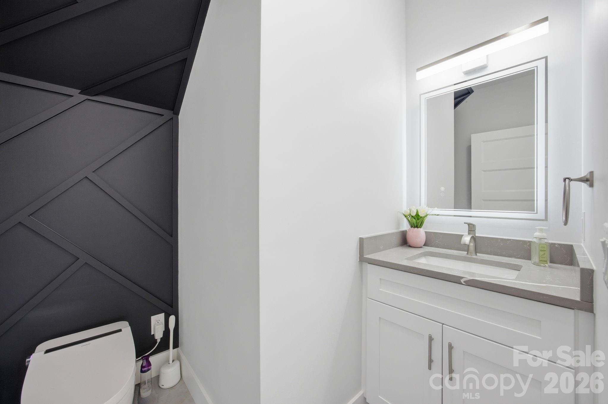 30 1st Street Canton, NC 28716 - Photo 15 of 39 a bathroom with a granite countertop sink and a mirror