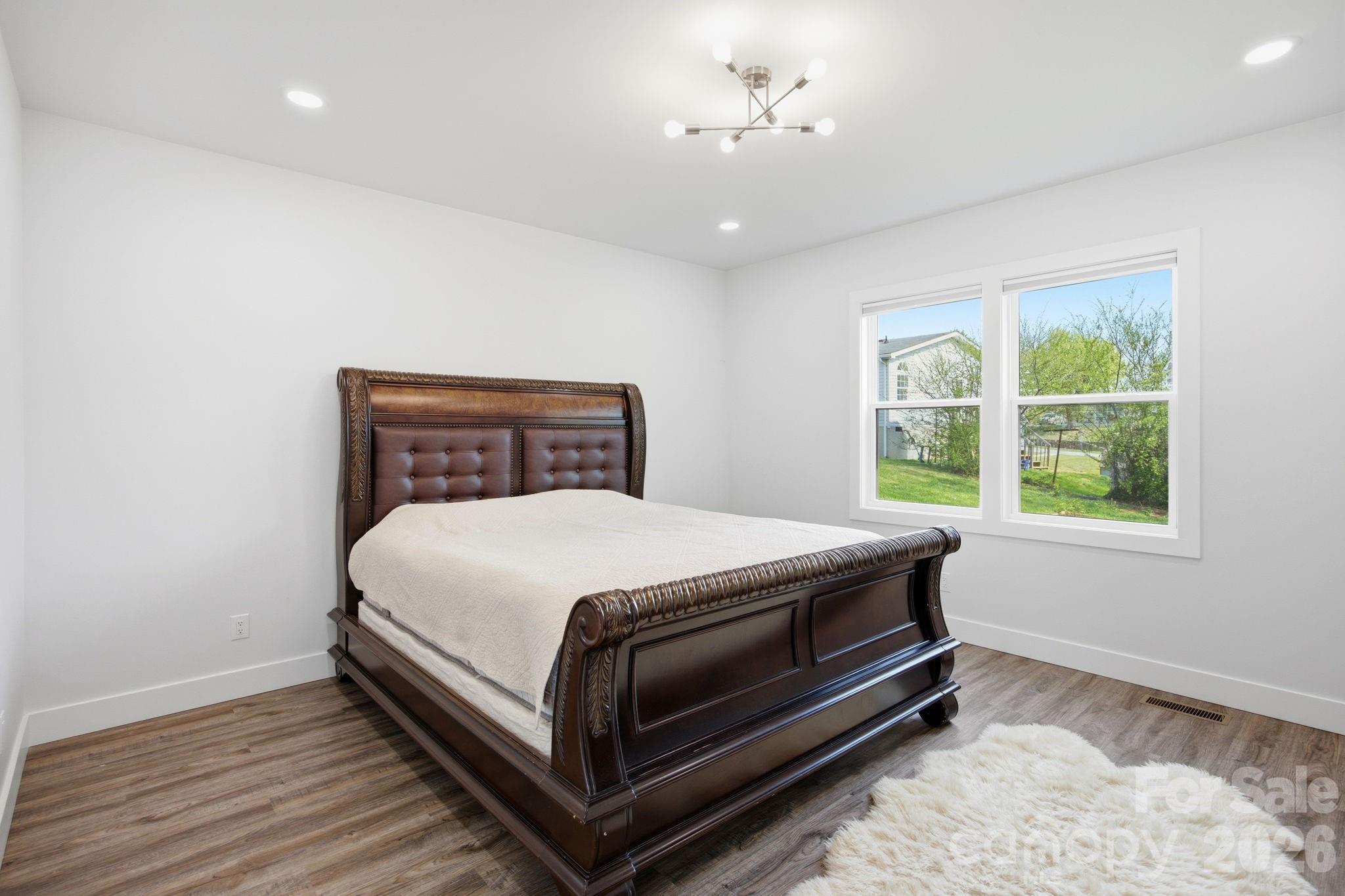 30 1st Street Canton, NC 28716 - Photo 16 of 39 a bedroom with a bed and a window