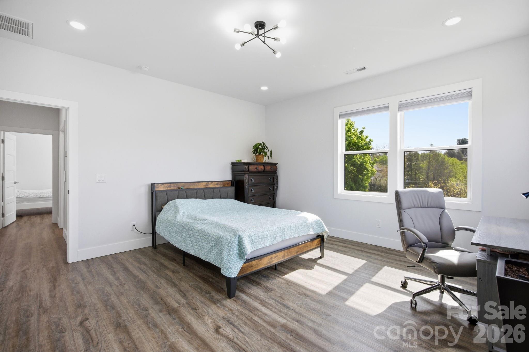 30 1st Street Canton, NC 28716 - Photo 22 of 39 a bedroom with a bed and a table