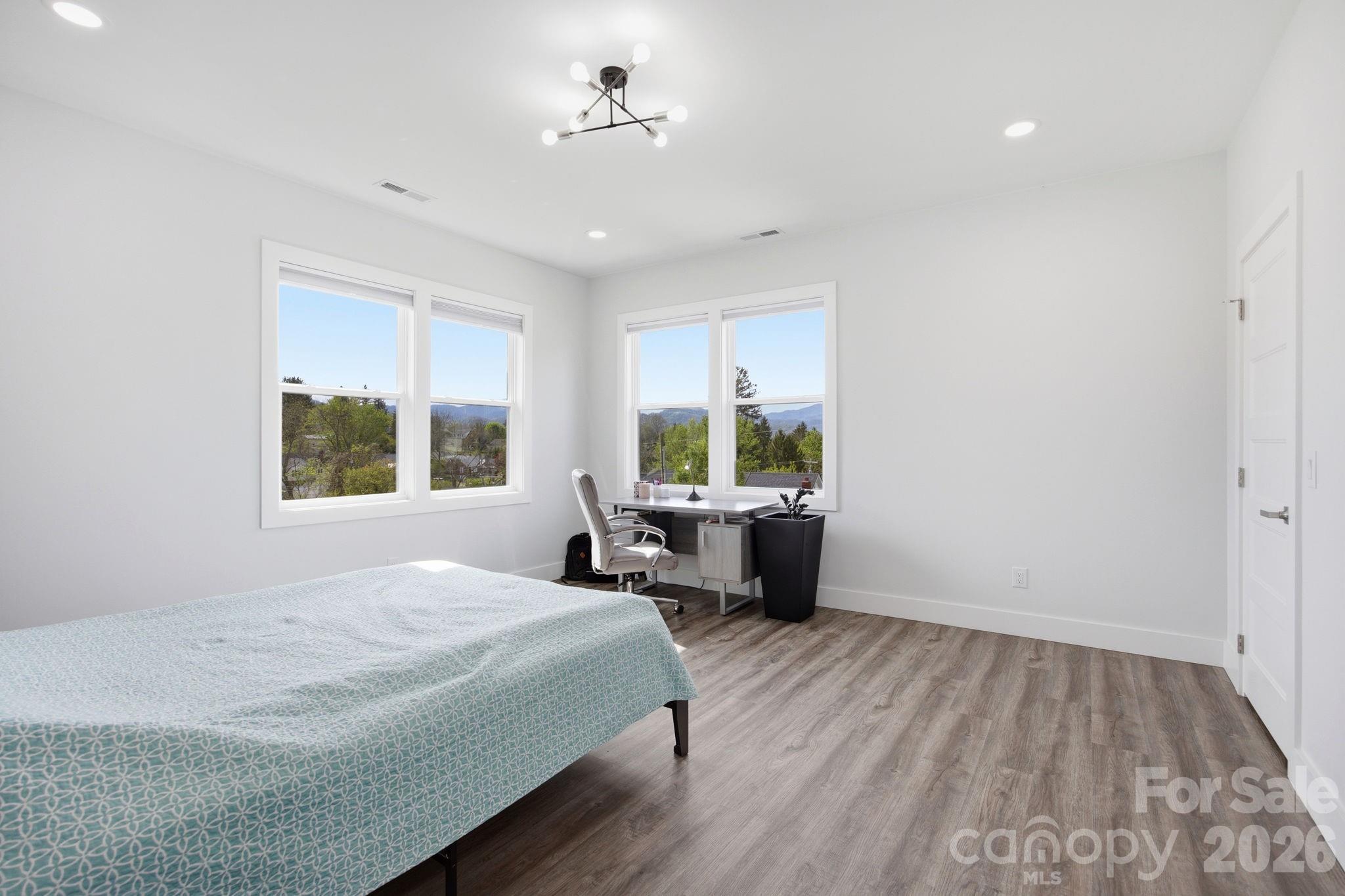 30 1st Street Canton, NC 28716 - Photo 23 of 39 a spacious bedroom with a bed and a window