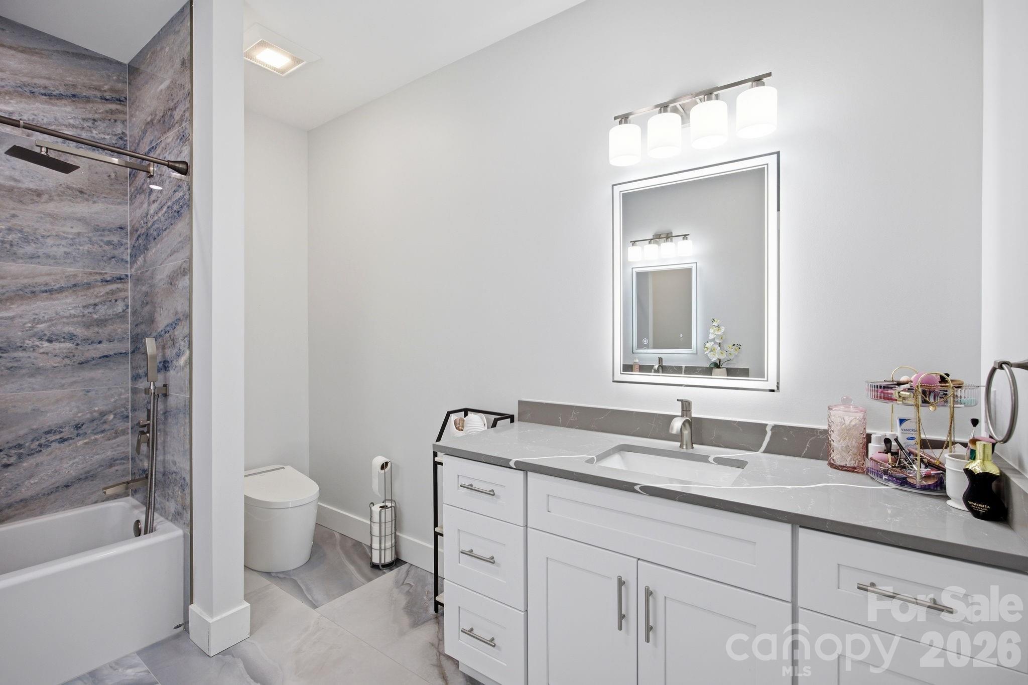 30 1st Street Canton, NC 28716 - Photo 24 of 39 a bathroom with a double vanity sink toilet and shower