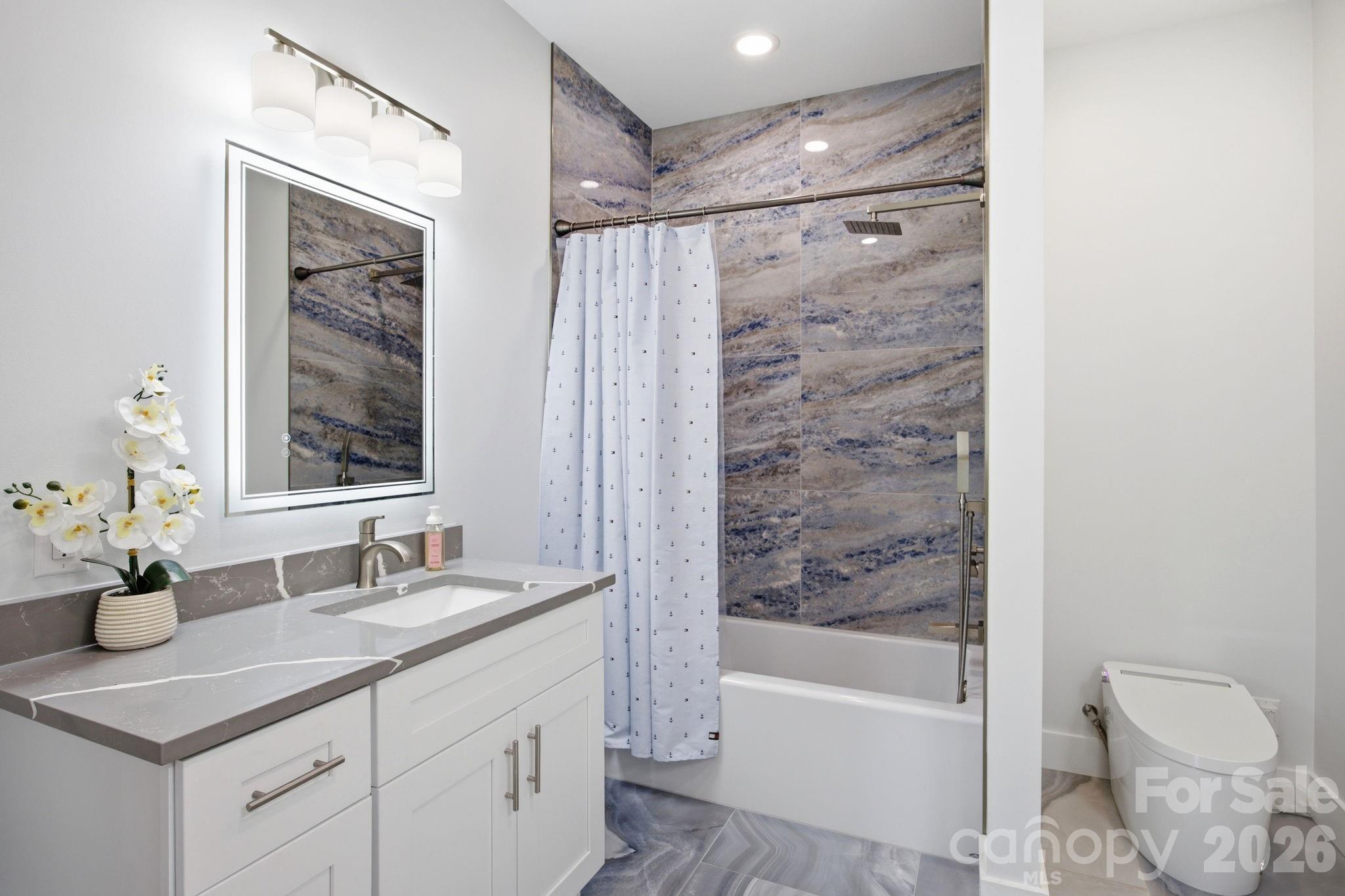 30 1st Street Canton, NC 28716 - Photo 25 of 39 a bathroom with a granite countertop sink a toilet and shower