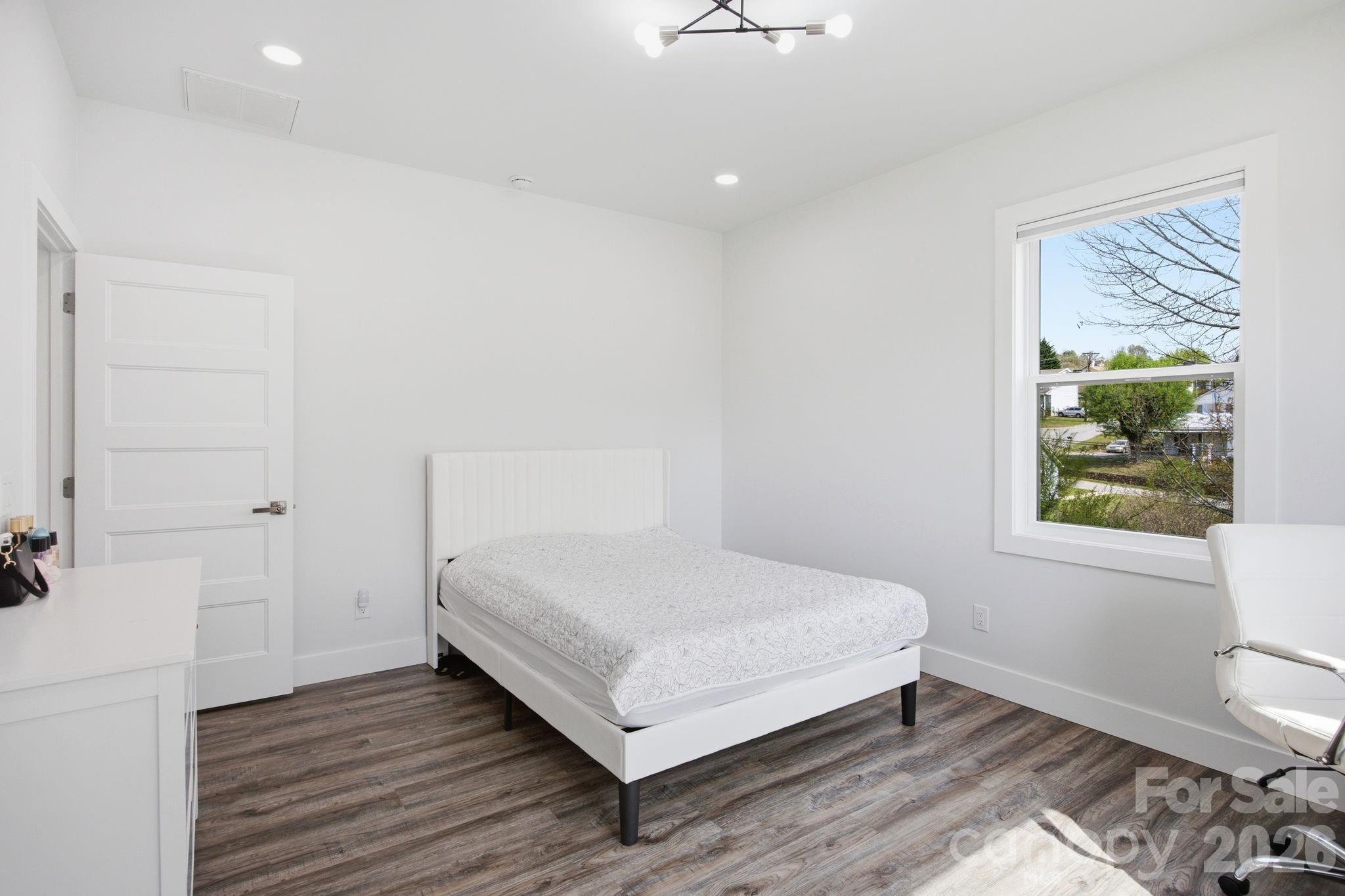 30 1st Street Canton, NC 28716 - Photo 27 of 39 a bedroom with a bed and a window