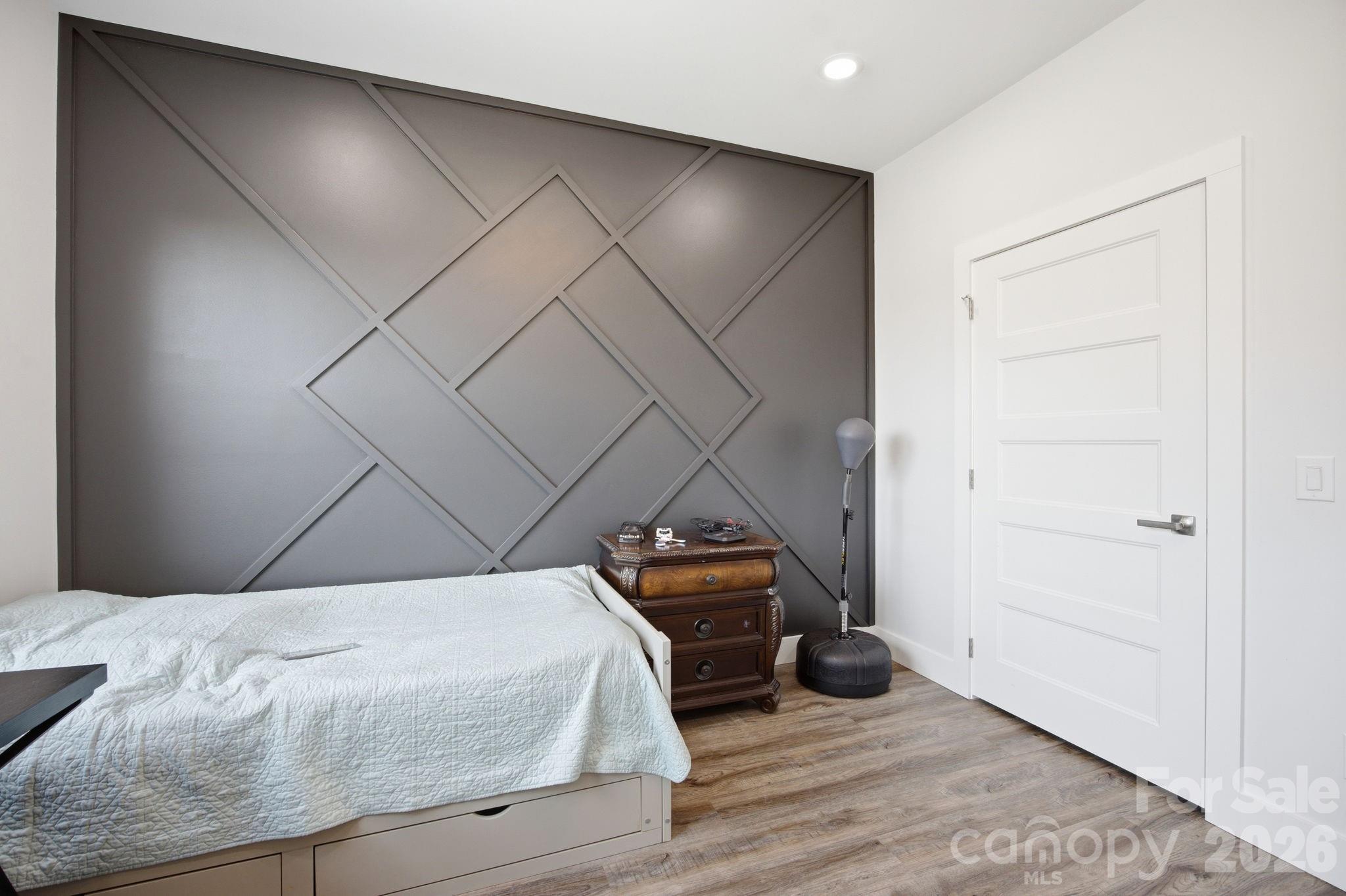30 1st Street Canton, NC 28716 - Photo 29 of 39 a bedroom with a bed and a wooden floor