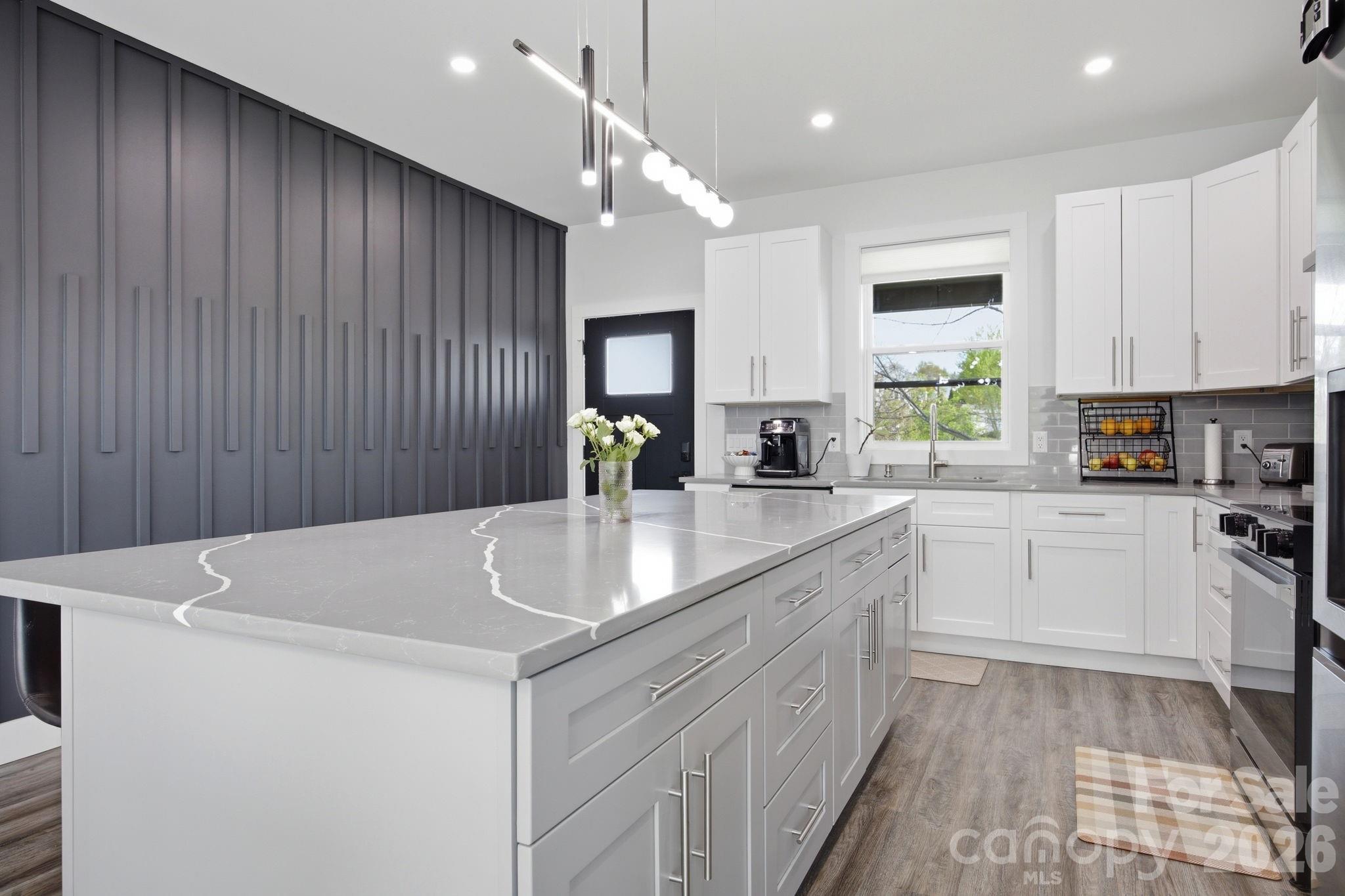 30 1st Street Canton, NC 28716 - Photo 10 of 39 a kitchen with stainless steel appliances a sink stove and cabinets