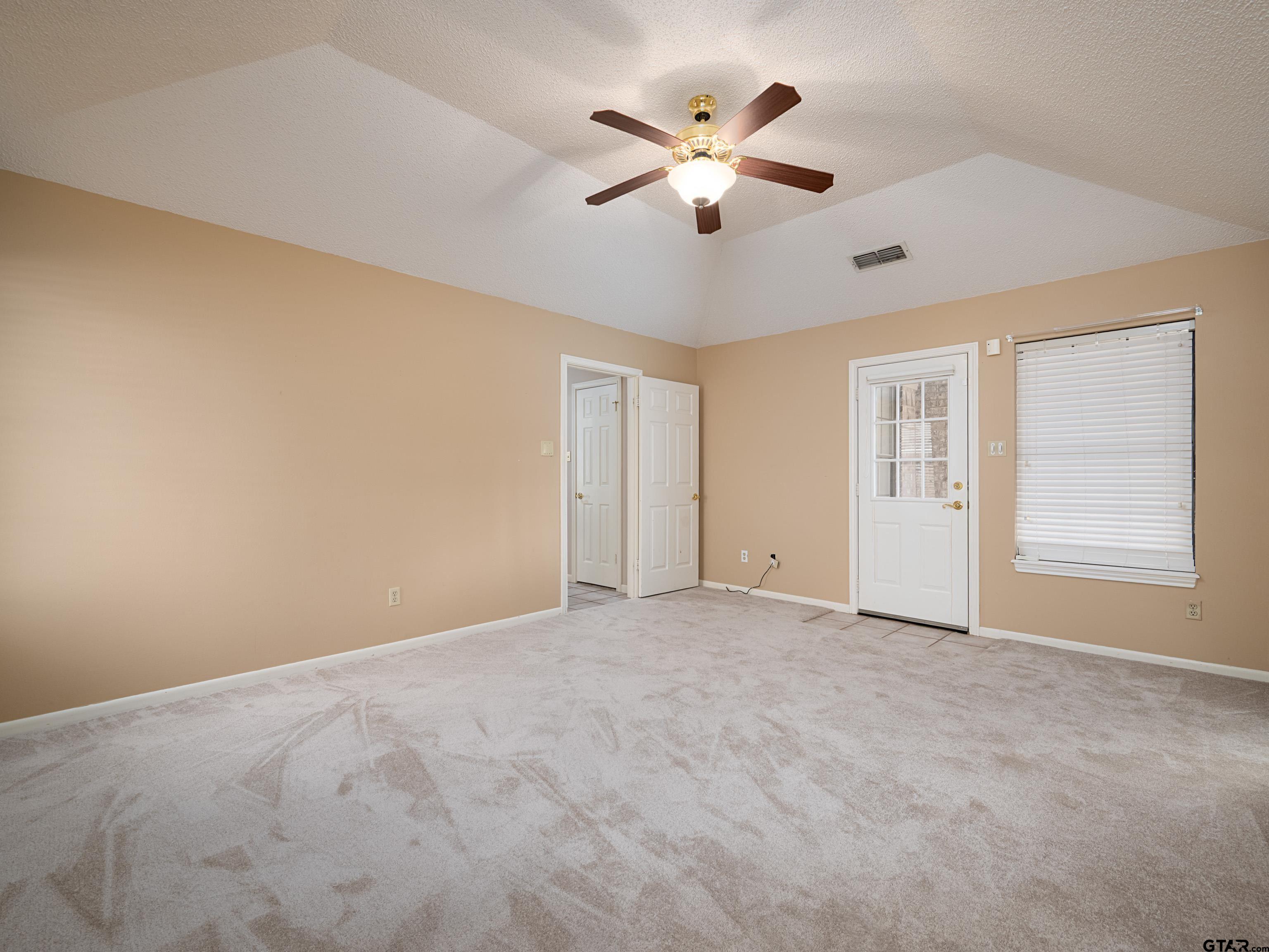 17984 Briarcrest Flint, TX 75762 - Photo 16 of 29 an empty room with chandelier fan and windows