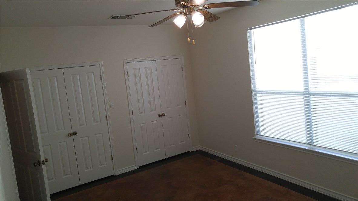 118 Sandstone Drive, Unit A Jarrell, TX 76537 - Photo 6 of 6 a view of an empty room with wooden floor and a window