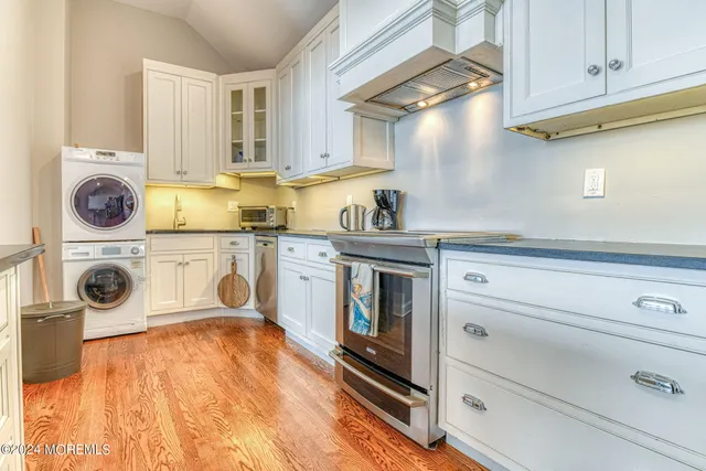 a kitchen with stainless steel appliances granite countertop a sink and cabinets