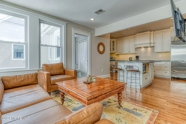 a living room with a couch and wooden floor