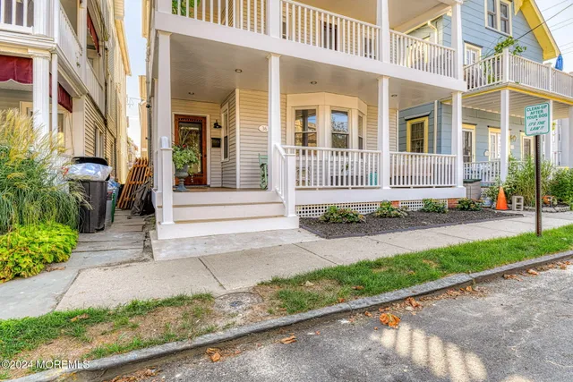 a front view of a building with a garden and plants