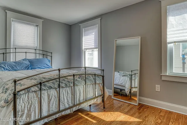 a bedroom with furniture window and a wooden floor