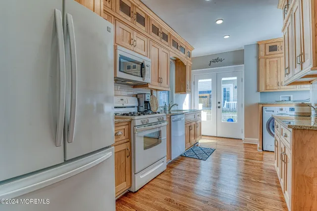 a kitchen with stainless steel appliances granite countertop a refrigerator and a stove top oven