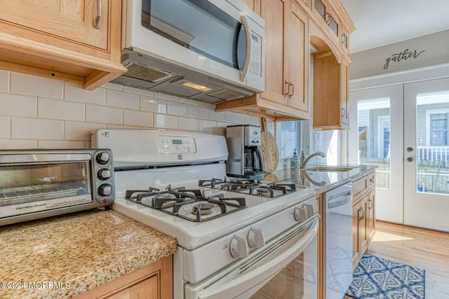 a kitchen with a stove and a refrigerator