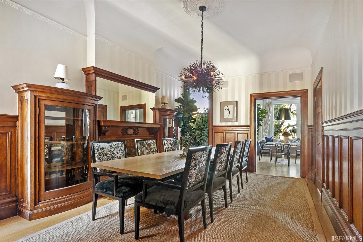 818 Steiner Street San Francisco, CA 94117 - Photo 11 of 74 Lower level is complete with a separate au pair or guest quarters that includes a bedroom/lounge and a full-bath which can be accessed separately though the home’s side entrance. Down the hall are a home gym & full-bathroom, a wine room, spacious laundry and utility areas, and a room with built-in storage that leads to the outdoor spa area with rain shower and cedar hot tub. There’s never been a better yard for entertaining; built-in seating, a roaring fire pit, and a concrete slide in its lower-level turf-lawn play space. This home offers a lifestyle surrounded by the beauty of Alamo Square Park, the vibrancy of Hayes Valley and Divisadero Corridor, and a clear connection to San Francisco’s downtown and beyond. 