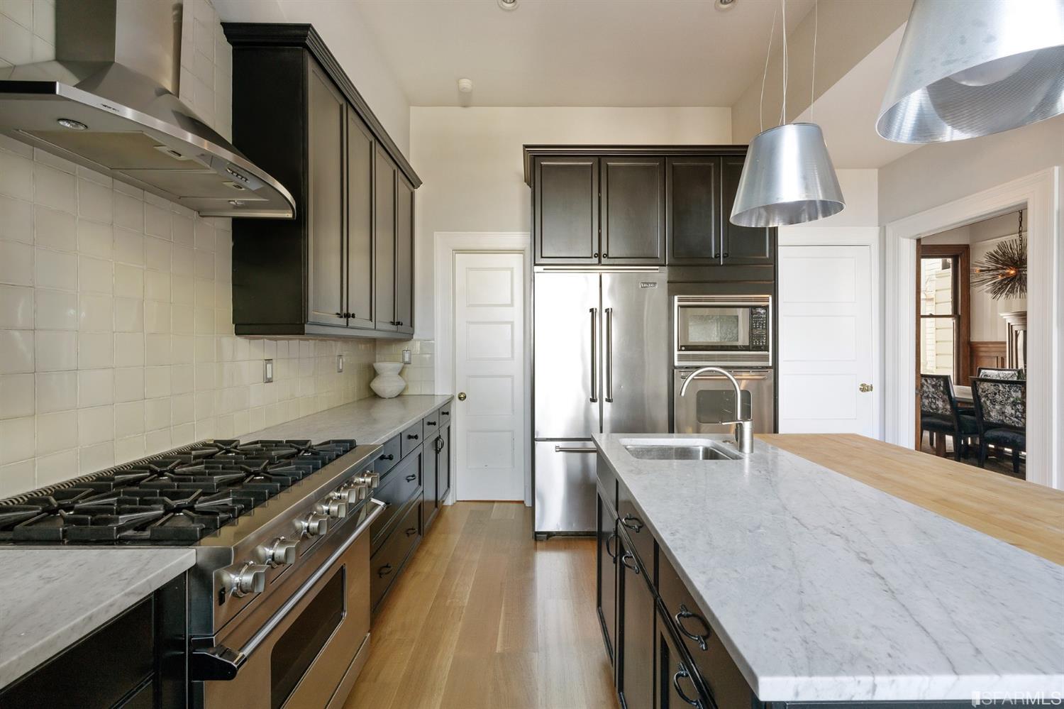 818 Steiner Street San Francisco, CA 94117 - Photo 13 of 74 Lower level is complete with a separate au pair or guest quarters that includes a bedroom/lounge and a full-bath which can be accessed separately though the home’s side entrance. Down the hall are a home gym & full-bathroom, a wine room, spacious laundry and utility areas, and a room with built-in storage that leads to the outdoor spa area with rain shower and cedar hot tub. There’s never been a better yard for entertaining; built-in seating, a roaring fire pit, and a concrete slide in its lower-level turf-lawn play space. This home offers a lifestyle surrounded by the beauty of Alamo Square Park, the vibrancy of Hayes Valley and Divisadero Corridor, and a clear connection to San Francisco’s downtown and beyond. 